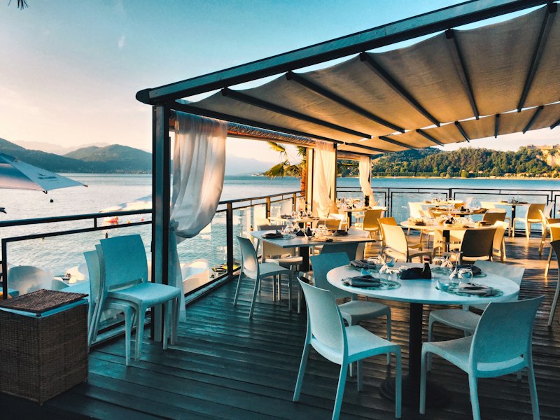 A waterfront restaurant terrace, the kind of local business we help owners buy and sell